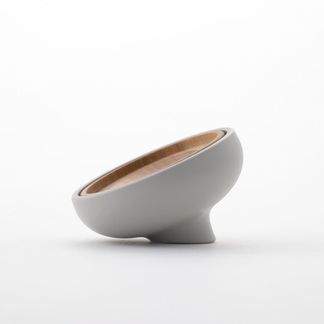 Side view of the Tailo pet memorial bell showing its rounded, tilted shape